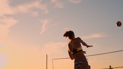 Young-girl-jump-serve-volleyball-on-the-beach-slow-motion